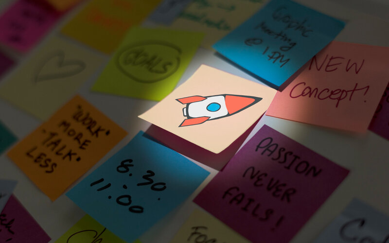 Sticky notes on rocket goals and motivation board for assumption testing